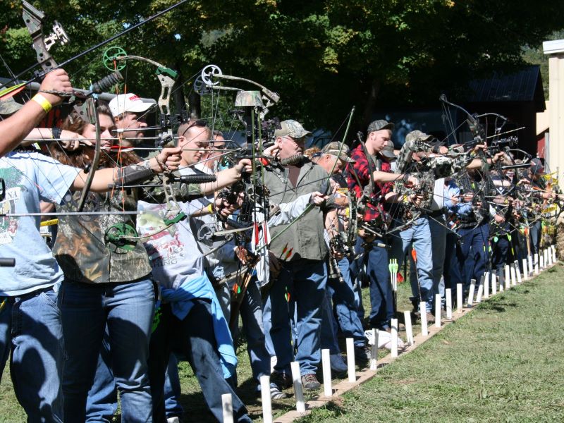 Line of bowhunters at archery competition