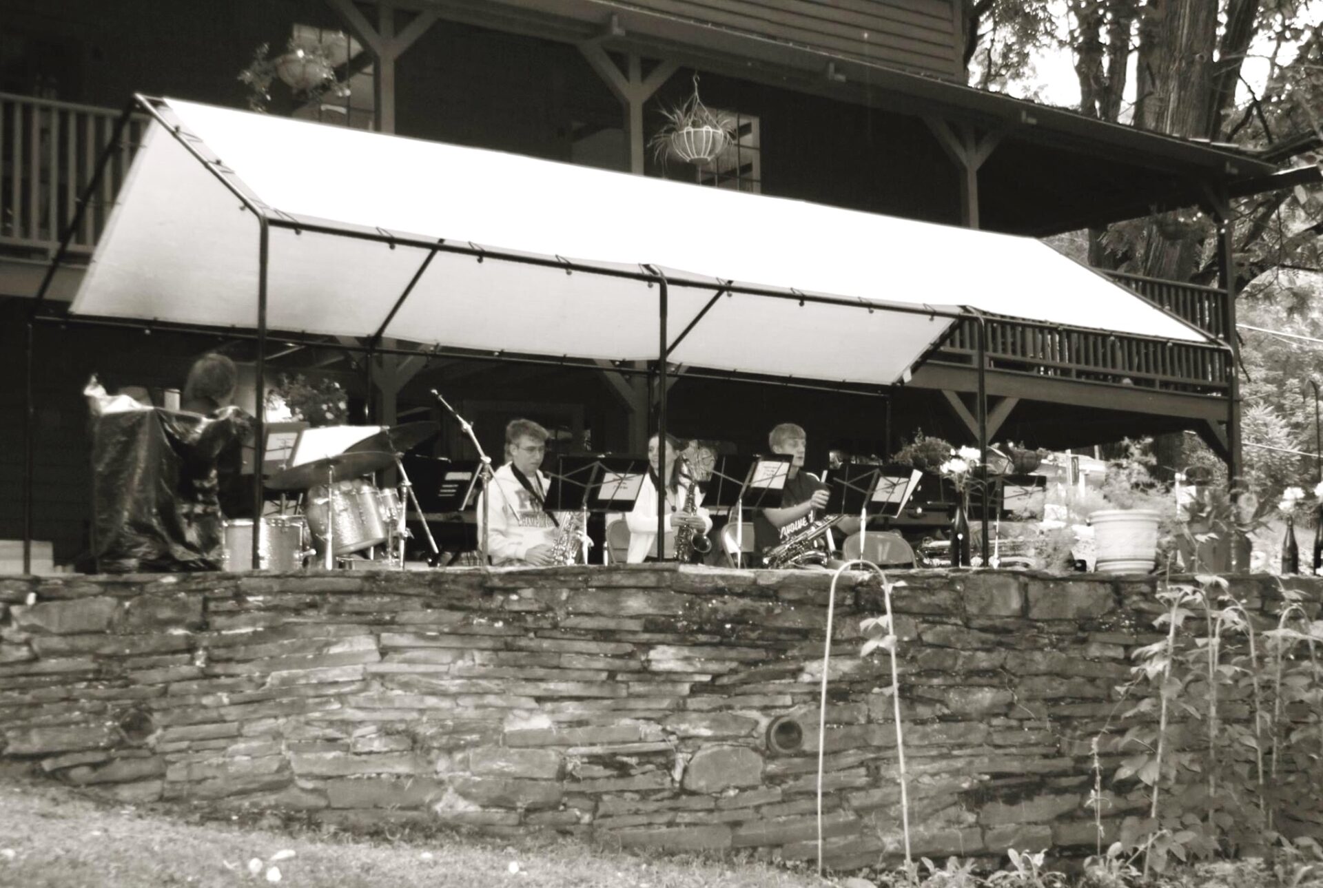 Musicians perform under a tent at Laceyville's Oldest House
