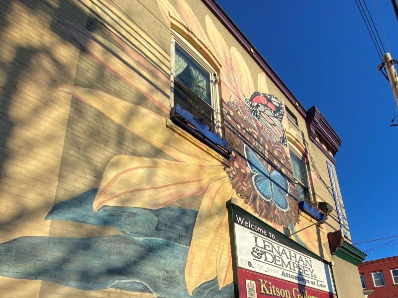 Mural of a blue butterfly and a Monarch butterfly resting on a sunflower