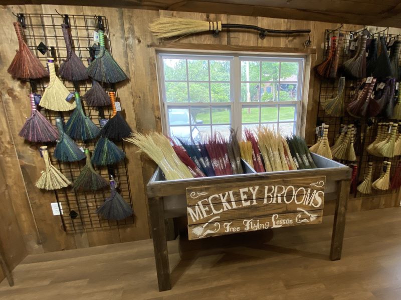 Display of whisk brooms and broom corn